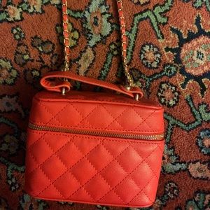 Red quilted crossbody bag with detachable chain